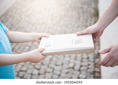 Close-up Of Hands Picking Up Package. Deliveryman