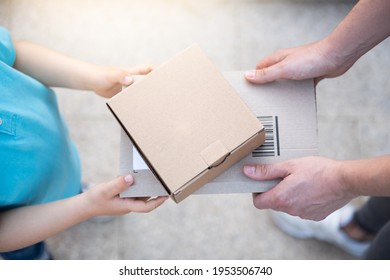 Close-up Of Hands Picking Up Package. Deliveryman.