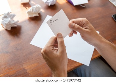 close-up of hands with a plan list sheet without notes
