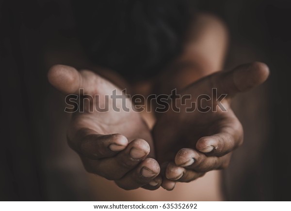 closeup hands poor\
child begging you for help concept for poverty or hunger people,\
Human Rights,background text.\
