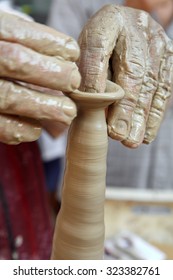 Closeup hands of a potter manufactures a jug