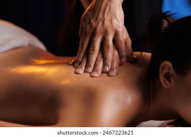 Close-up hands of professional masseuse working, massaging woman's back in spa salon, therapeutic massage for muscle relaxation. Healing, beauty, health, lifestyle, peace, relief, professional skills. - Powered by Shutterstock