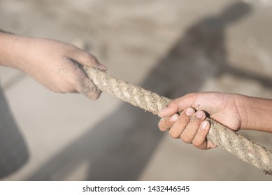 Closeup of a hands pulling a rope. concept of teamwork, rival and effort. selective focus on hand