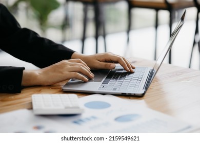 Close-up of hands resting on keyboard to view financial data, business growth in the world of cryptocurrencies and the current global economy with war and volatility. Finance and investment concepts. - Shutterstock ID 2159549621