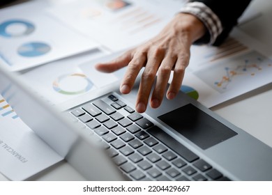 Close-up Of Hands Resting On Keyboard To View Financial Data, Business Growth In The World Of Cryptocurrencies And The Current Global Economy With War And Volatility. Finance And Investment Concepts.