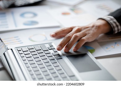 Close-up Of Hands Resting On Keyboard To View Financial Data, Business Growth In The World Of Cryptocurrencies And The Current Global Economy With War And Volatility. Finance And Investment Concepts.