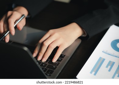 Close-up Of Hands Resting On Keyboard To View Financial Data, Business Growth In The World Of Cryptocurrencies And The Current Global Economy With War And Volatility. Finance And Investment Concepts.