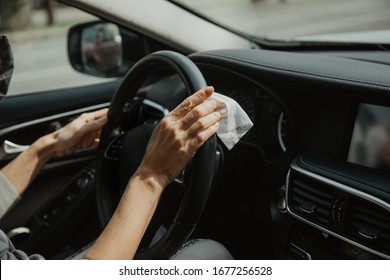 Close-up Hands Rub The Steering Wheel Of The Car With An Antibacterial Wipe