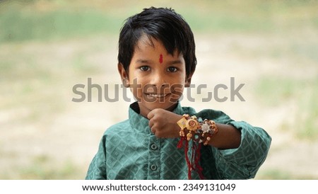 Closeup of hands, sister tying rakhi, Raksha bandhan to brother's wrist during festival or ceremony - Rakshabandhan celebrated across India as selfless love or relationship between brother and sister