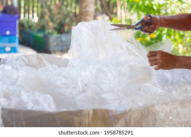 Closeup Hands Thai Women Are Sorting Out Waste Plastic Bag With  Scissors For Recycling.Enviromental Care Concept