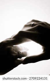 Close-up of hands touching in soft light
