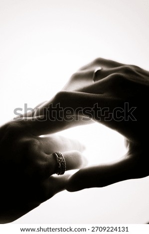 Close-up of hands touching in soft light