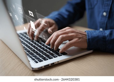 Close-up of hands typing on a laptop with digital interface icons overlayed, showcasing online communication and technology.