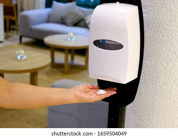 Closeup of Hands under the automatic alcohol dispenser. Sanitation station for cleaning of hands. Infection prevention concept. Selective focus closeup.  - Shutterstock ID 1659504049