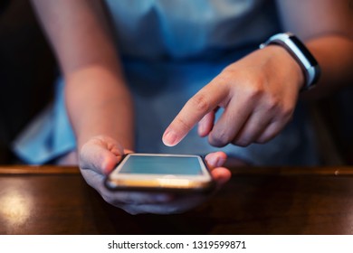 Closeup of hands using internet on mobile. Wireless network connection technology concept.