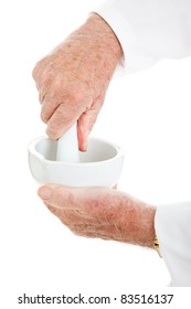 Closeup of hands using a mortar and pestle.  Isolated on white.