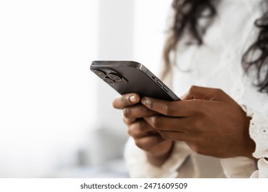 Closeup of hands using phone. Unrecognisable black person using phone with copy space - Powered by Shutterstock