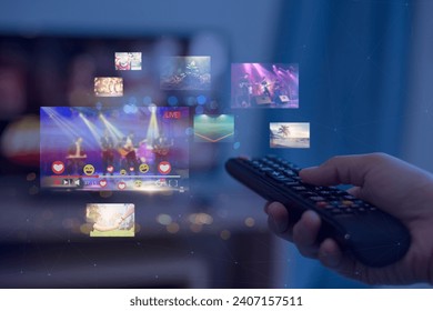 Close-up of hands using remote smart tv on blurred smart tv with video on demand as background