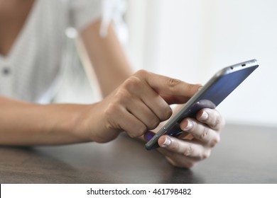 Closeup of hands using smartphone