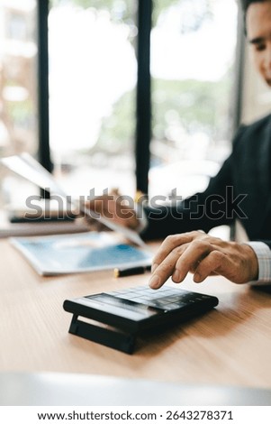 Close-up of hands working with computer tablet in modern office. Preparing accounting analysis report, real estate investment information, financial and tax system concept.