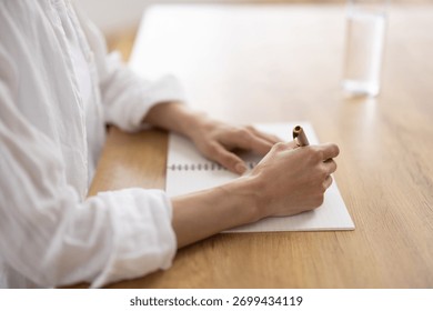Close-Up of Woman’s Hands Writing Notes in Notebook