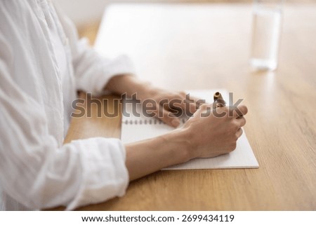 Close-Up of Woman’s Hands Writing Notes in Notebook