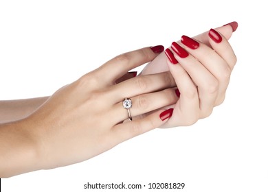 Closeup Hands Of Young Woman With Red Manicure Polished Nails Wearing An Expensive Engagement Ring With A Diamond