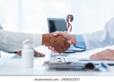 close-up handshake between two individuals, doctor and other casual shirt. doctor-patient relationship, agreement on treatment plan,  conclusion of medical consultation. - Powered by Shutterstock