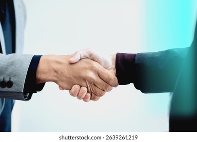 Close-up of a handshake between two people in business attire, symbolizing agreement and partnership. Professional handshake, business handshake, partnership. Business team and collaboration image.
