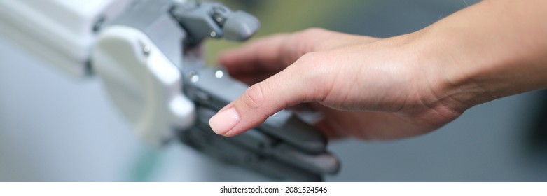 Closeup Of Handshake Of Female Hand And Artificial Prosthesis