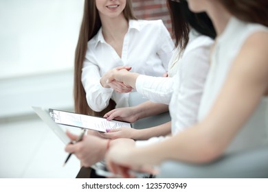 closeup handshake financial partners after discussing the terms of the contract - Shutterstock ID 1235703949