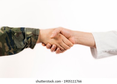 A Closeup Of A Handshake Of A Soldier And A Doctor