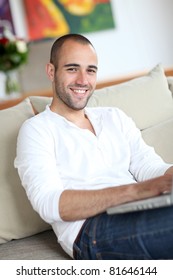 Closeup Of Handsome Man Websurfing On Laptop Computer