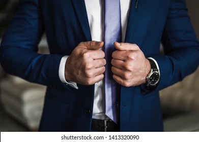 Close-up Handsome And Successful Man In An Expensive Suit. He Is In A White Shirt With A Tie. A Strong, Stylish Successful Man In A Suit Posing. A Man Puts On A Suit. Businessman In An Expensive Suit