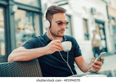  Close-up of handsome young man while listening to music - Shutterstock ID 491994370