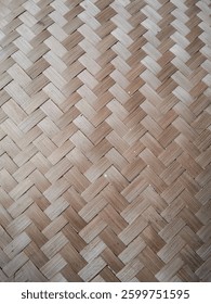Closeup of a handwoven bamboo pattern featuring natural tones. Ideal for design, artisanal craft, and eco-friendly themes emphasizing tradition and sustainabilit