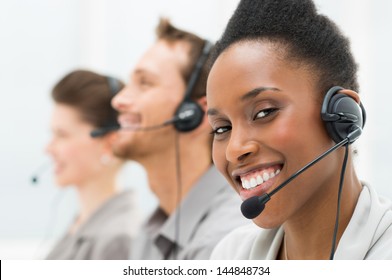 Closeup Of Happy African American Telephone Operator with Her Colleagues