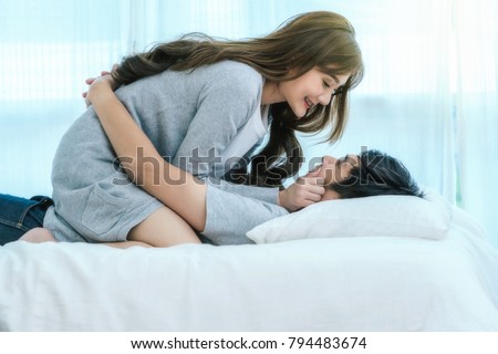 Similar – Image, Stock Photo Young couple in love embracing lying over a bed