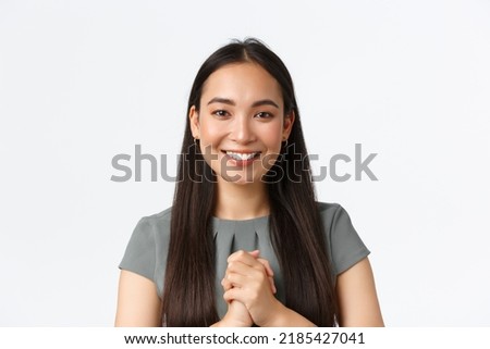 Close-up of happy attractive asian woman receiving award or praises at work, holding hands clasped together in thankful appreciation gesture, smiling, thanking for given opportunity, white background