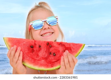 close-up of happy cool trendy funky hipster blonde girl in sunglasses eating ripe red watermelon by sea, juicy slice in hands of child, toddler, smiling joyfully, happy childhood, life is beautiful - Shutterstock ID 2283361981