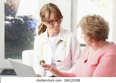 Close-up of happy female doctor talking with senior patient at clinic.