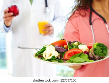 Close-up Of A Happy Friendly Beautiful Nurse Holding Stethoscope About To Check A Heartbeat