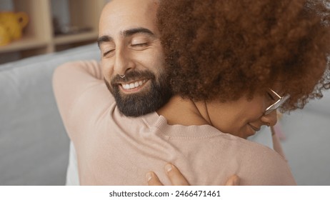 Close-up of a happy interracial couple embracing in a cozy indoor setting, reflecting love and contentment. - Powered by Shutterstock