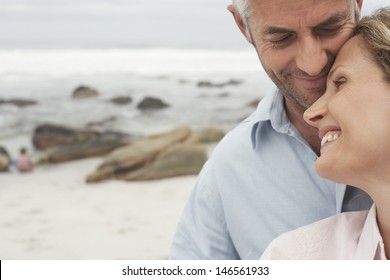 Closeup of happy loving couple spending leisure time together at beach - Powered by Shutterstock