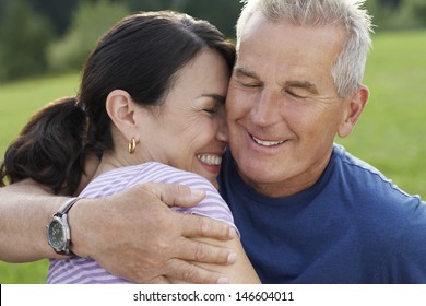 Closeup Of A Happy Mature Man And Middle Aged Woman Embracing