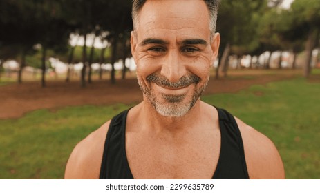 Close-up happy mature muscular man in sportswear looking at camera and smiling - Shutterstock ID 2299635789