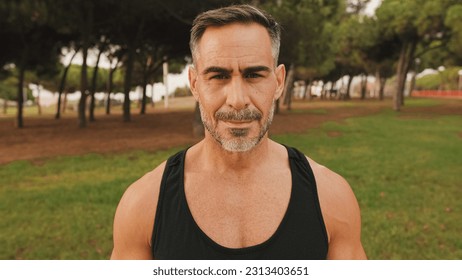 Close-up happy mature muscular man in sportswear looking at camera and smiling - Shutterstock ID 2313403651