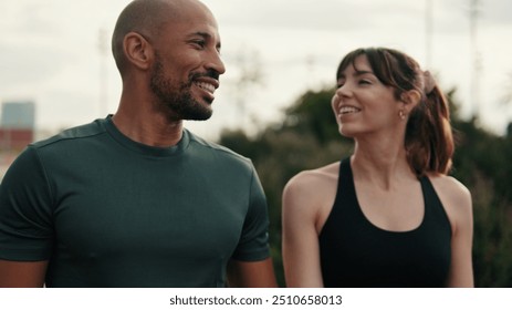 Close-up of happy multiethnic male and female athletes walking outdoors in sportswear. Motivation and dreams, active lifestyle, training and healthy routine. Сouple goals and motivation - Powered by Shutterstock