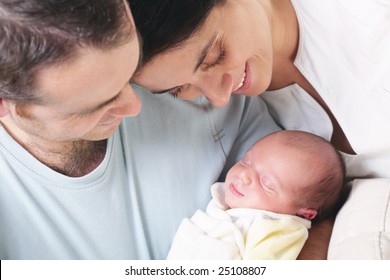 close-up of happy parents holding their newborn baby