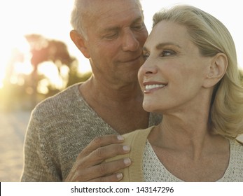 Closeup of happy senior couple spending quality time on tropical beach